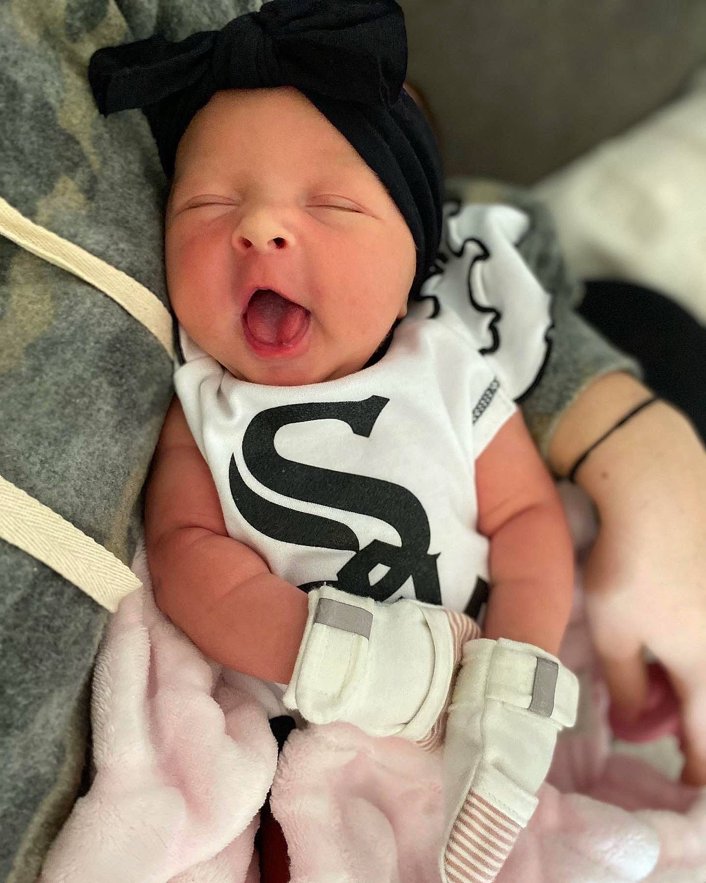 Elsie is registered to the contest to win money with this photo: baby, baby_products, baby_sleeping, baby_toddler_clothing, cheek, child, comfort, cool, fashion_accessory, finger, gesture, happy, hat, headwear, nail, person, skin, sleeve, smile, thumb