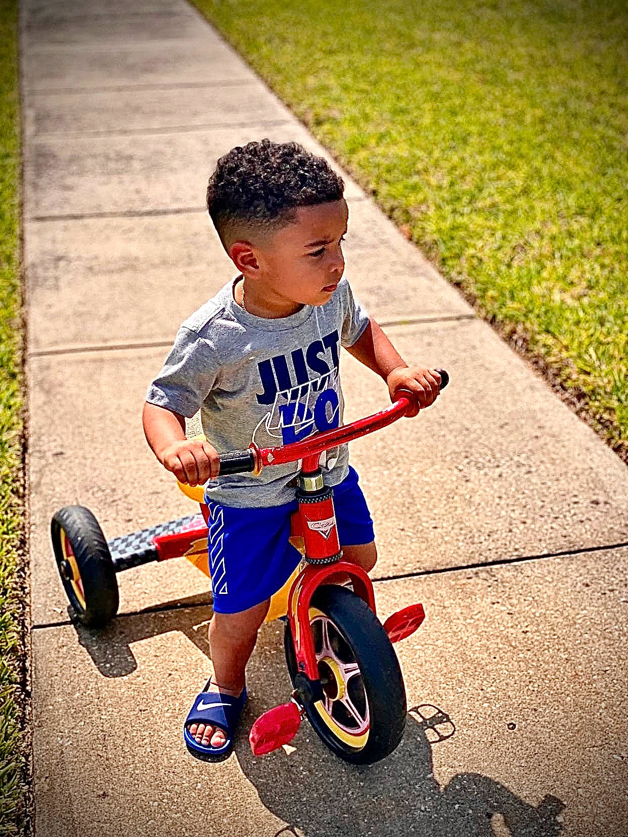 Yehezquiel joined the competition — help win amazing prizes! automotive_tire, bicycle, bicycle_accessory, bicycle_frame, bicycle_part, bicycle_tire, bicycle_wheel, cool, grass, happy, people_in_nature, person, recreation, riding_toy, road, rolling, shorts, spoke, tire, toddler
