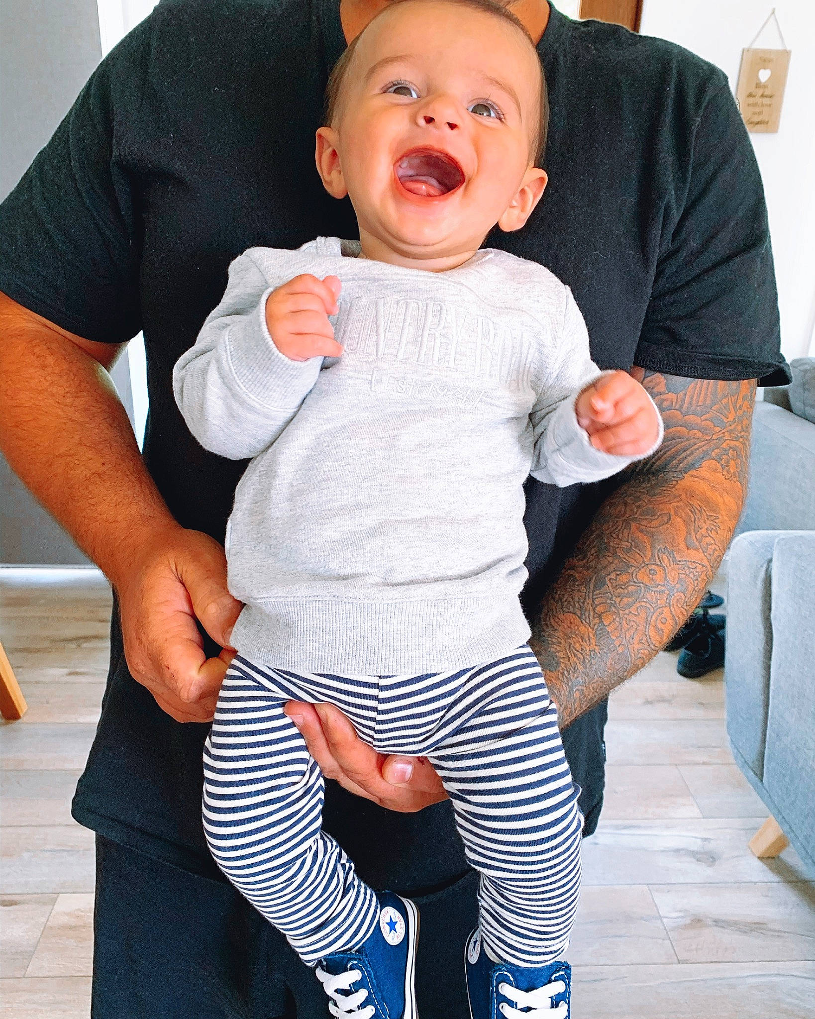 Henley is registered to the contest to win money with this photo: arm, baby, baby_products, baby_toddler_clothing, blue, cheek, child, facial_expression, happy, laugh, leg, leggings, person, product, skin, sleeve, smile, t_shirt, toddler
