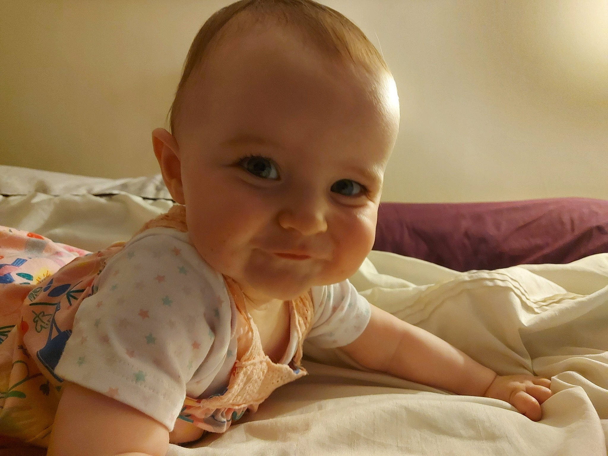 Darcy is registered to the contest to win money with this photo: baby, cheek, child, chin, ear, eye, face, finger, forehead, head, mouth, nose, person, sitting, skin, smile, toddler, tummy_time