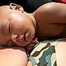 Tyrone joined the competition — help win amazing prizes! baby, sleeping, face, skin, arm, camouflage, clothing, child, peaceful, closeup, rest, portrait, human, infant, napping, cute, soft_light, relaxation, indoors, person