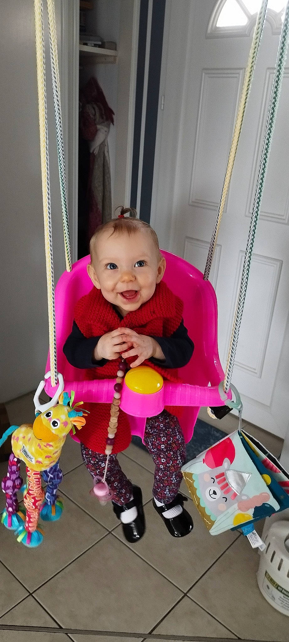 Naëlle participe au concours pour gagner de l'argent avec cette photo : baby, baby_products, baby_toddler_clothing, child, curtain, face, fun, happy, magenta, person, pink, product, purple, room, shoe, sitting, smile, sock, stuffed_toy, toddler