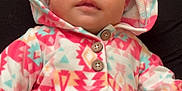 Genesis is registered to the contest to win money with this photo: baby, child, hoodie, onesie, patterned_clothing, colorful, infant, face, eyes, mouth, button, fabric, soft, cute, lying_down, portrait, indoor, apparel, person, baby_garment
