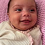 Genesis is registered to the contest to win money with this photo: baby, infant, smile, face, clothing, blanket, pink, cream, knitted, happy, portrait, child, cute, young, soft, resting, indoors, closeup, person, cozy
