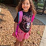 Kennedi joined the competition — help win amazing prizes! child, girl, smiling, outdoor, daylight, backpack, minnie_mouse, tshirt, pink_shorts, sneakers, long_hair, rocky_ground, sidewalk, brick_wall, plants, tree, sunlight, portrait, happy, casual_clothing