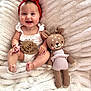baby, infant, smiling, red_headband, white_outfit, wooden_sign, five_months, knitted_toy, deer_doll, plush_blanket, cute, happy, sitting, portrait, indoors, child, soft_texture, cozy, accessory, bracelet