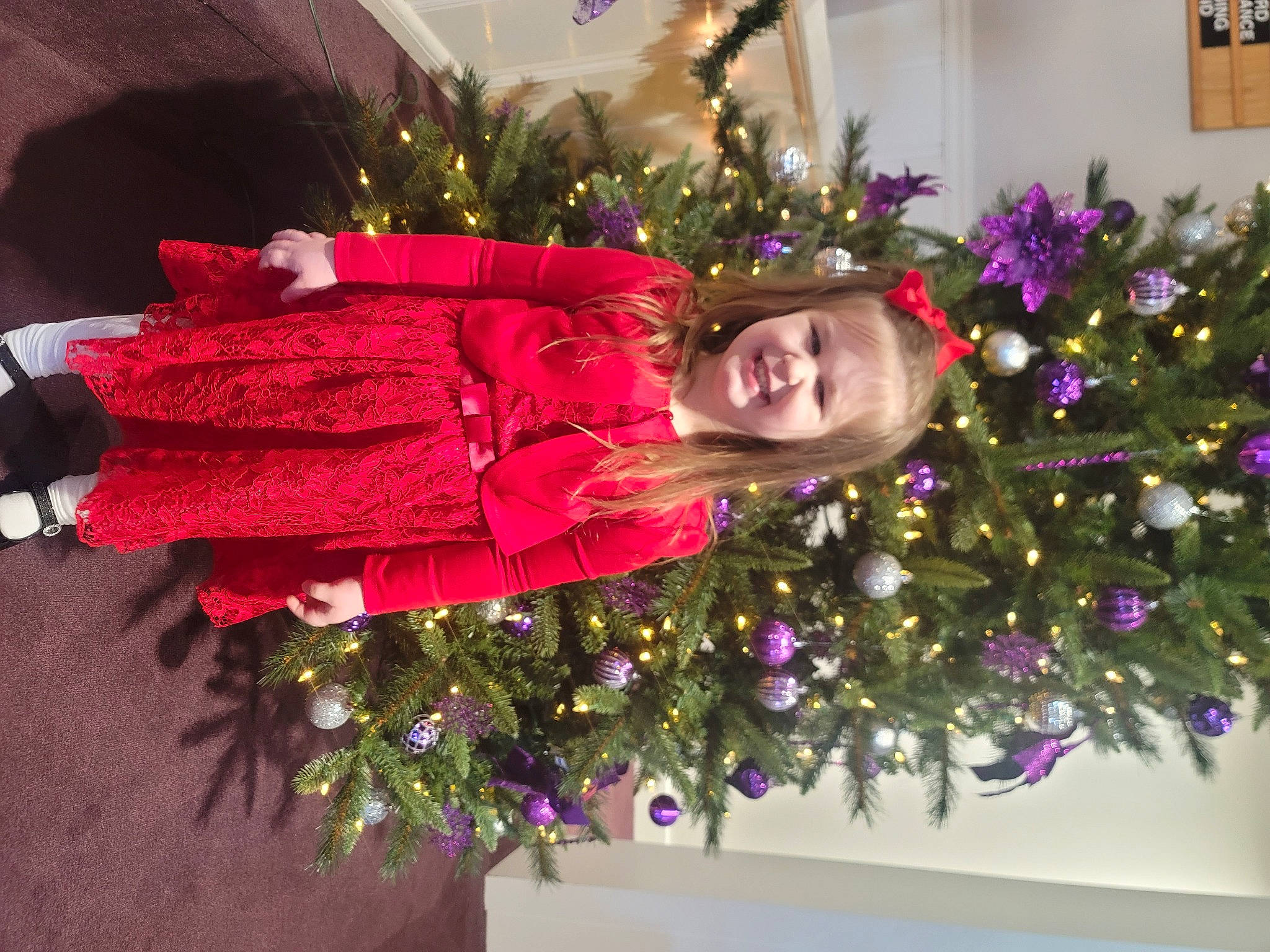 Tessa joined the competition — help win amazing prizes! christmas, christmas_decoration, christmas_eve, christmas_ornament, christmas_tree, conifer, decoration, dress, event, evergreen, holiday, holiday_ornament, joy, magenta, ornament, person, plant, purple, smile, tradition