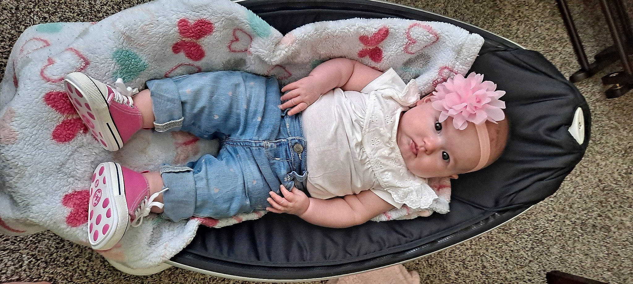 Madison is registered to the contest to win money with this photo: baby, baby_carriage, baby_products, baby_sleeping, baby_toddler_clothing, carmine, child, comfort, finger, headgear, headwear, lap, leg, mouth, pattern, person, pink, product, sitting, textile