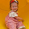 toddler, child, smiling, yellow_slide, outdoor, playground, red_bow, white_bow, checkered_outfit, white_shoes, grass, happy, cute, sitting, play, summer, fun, young_child, person, casual_clothing
