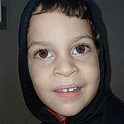 Jenfrey is registered to the contest to win money with this photo: boy, brown_eyes, casual, casual_clothing, child, childhood, closeup, cute, dark_background, expression, face, fashion, happy, hoodie, indoor, person, portrait, smiling, sweatshirt, young