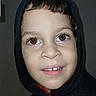 boy, brown_eyes, casual, casual_clothing, child, childhood, closeup, cute, dark_background, expression, face, fashion, happy, hoodie, indoor, person, portrait, smiling, sweatshirt, young