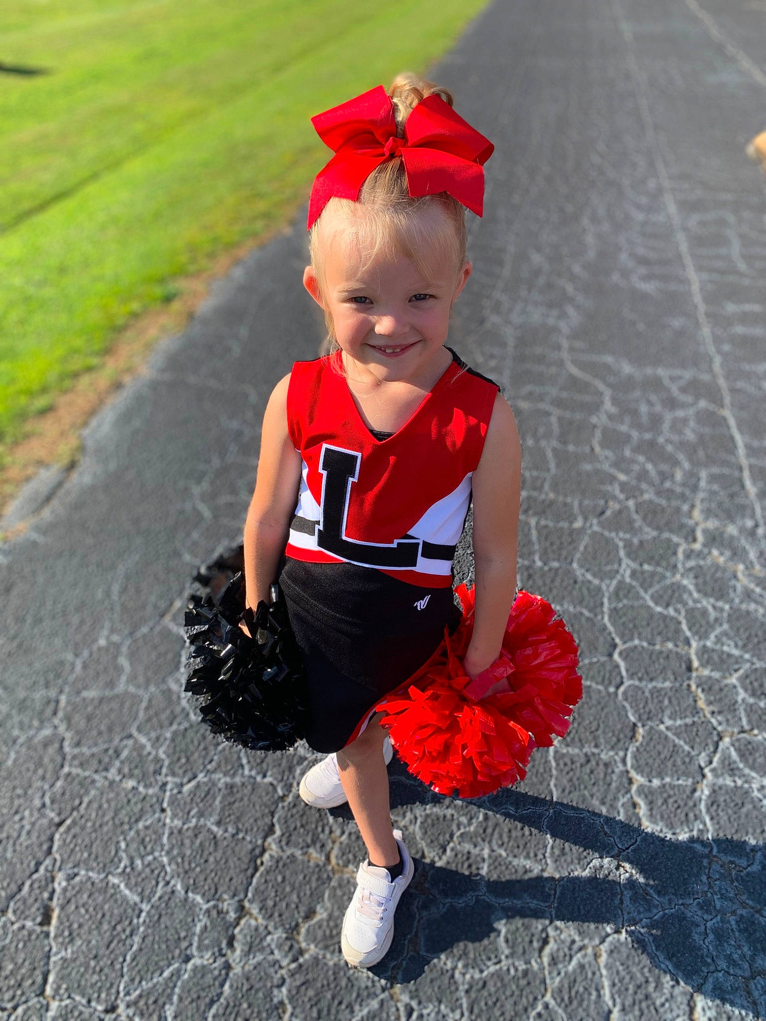 Aubree is registered to the contest to win money with this photo: asphalt, baby_toddler_clothing, carmine, child, electric_blue, event, flooring, fun, grass, happy, headgear, joy, magenta, party_supply, pattern, person, personal_protective_equipment, plant, recreation, road_surface