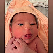 Saïna participe au concours pour gagner de l'argent avec cette photo : newborn, baby, infant, face, tongue, hands, peach_towel, hood, cute, skin, expression, closeup, child, portrait, soft, blanket, indoors, sleepwear, newborn_baby, adorable
