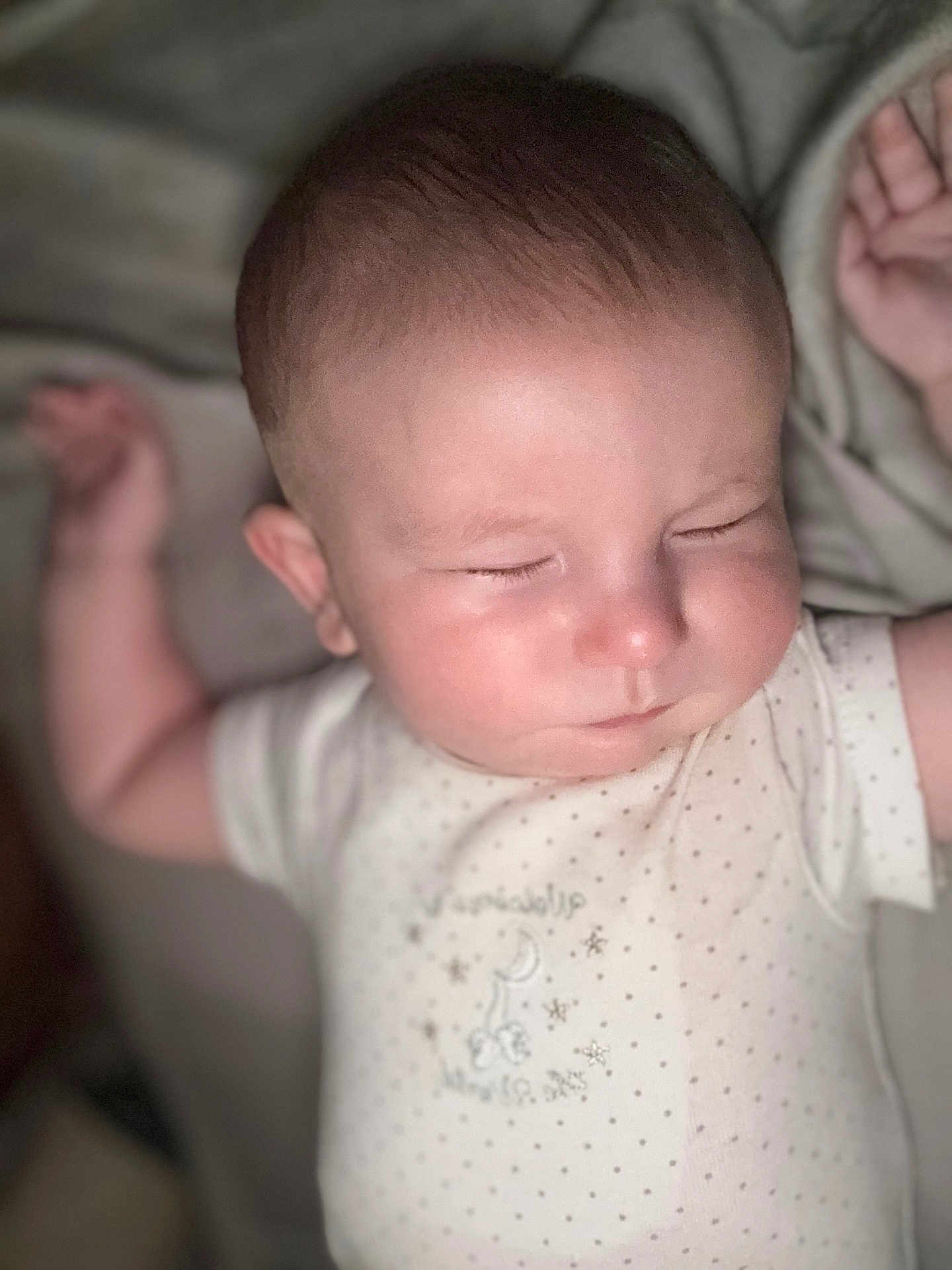 Wyatt is registered to the contest to win money with this photo: baby, sleeping, infant, arm, face, onesie, polka_dots, soft_light, close_up, peaceful, skin, head, cute, child, resting, indoors, portrait, newborn, expression, relaxation