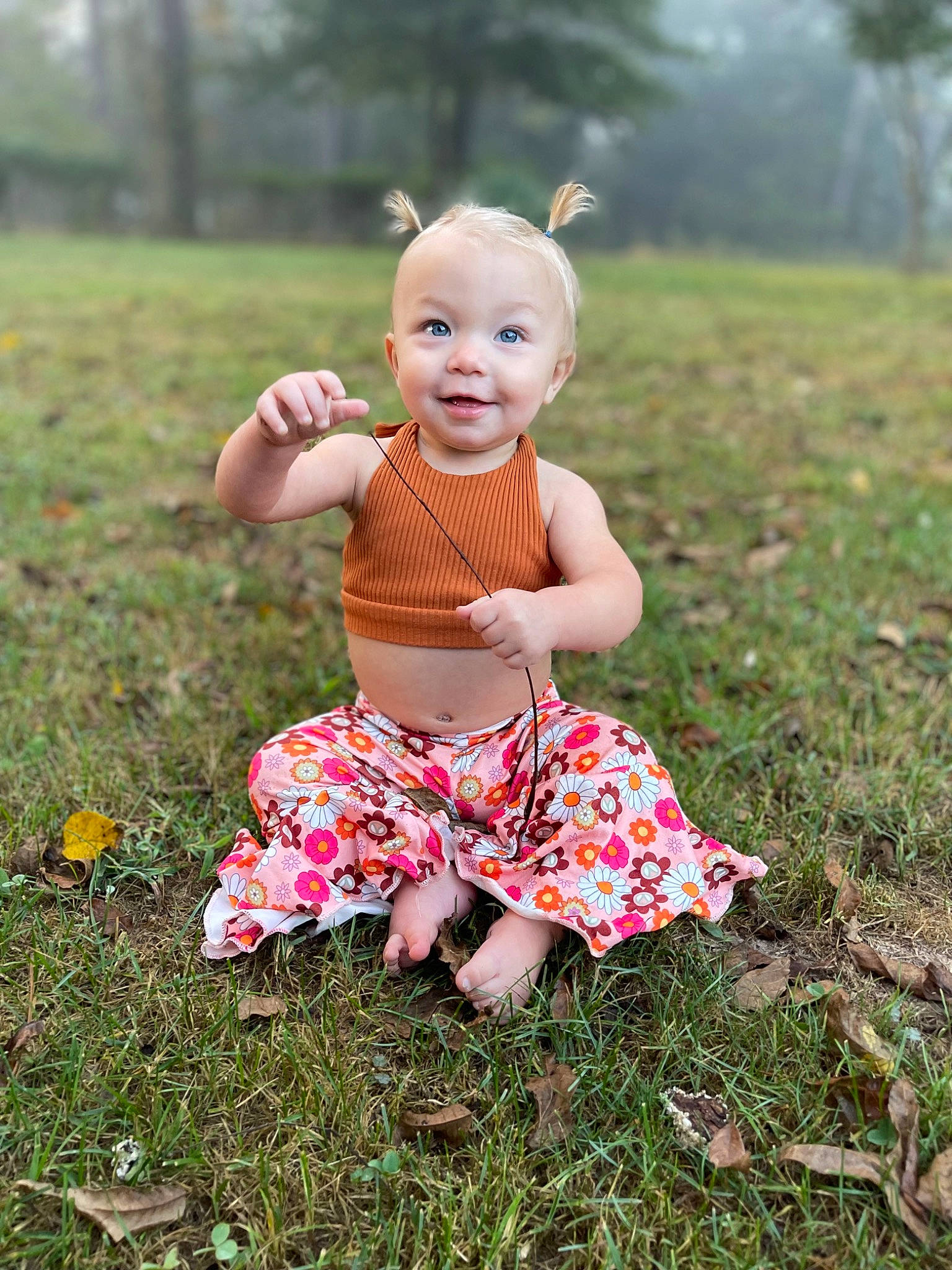 Bristol is registered to the contest to win money with this photo: baby, baby_toddler_clothing, child, grass, grass_family, grassland, happy, joy, lawn, meadow, pattern, people_in_nature, person, pink, plant, prairie, sitting, smile, spring, summer