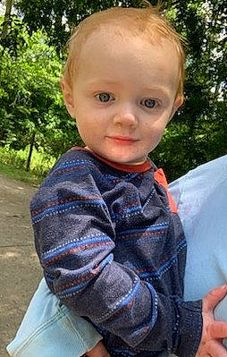 Oakley joined the competition — help win amazing prizes! baby_toddler_clothing, child, chin, electric_blue, finger, grass, happy, leisure, lip, neck, pattern, people_in_nature, person, plant, sitting, sleeve, t_shirt, thumb, toddler, tree