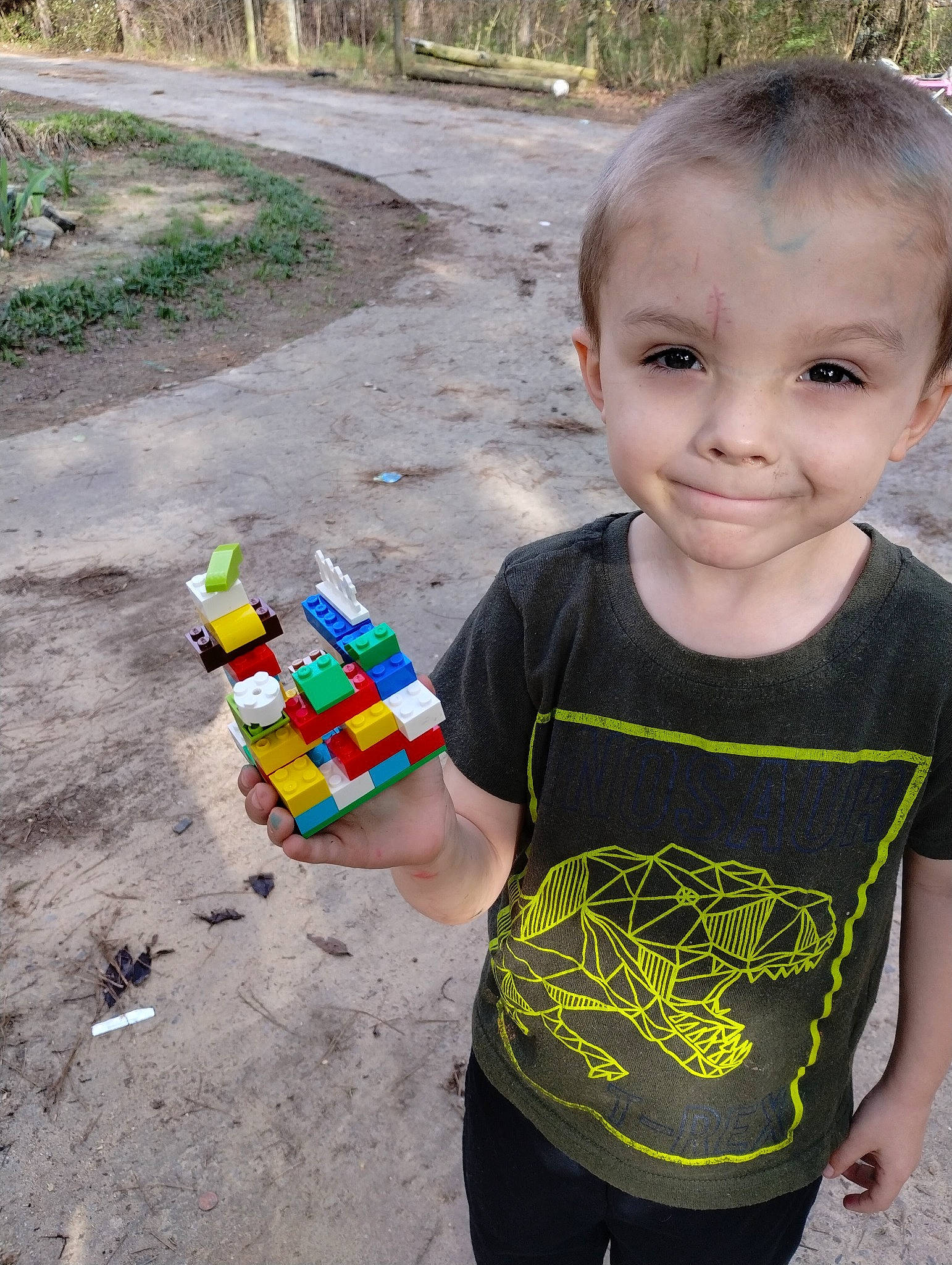 Memphis is registered to the contest to win money with this photo: asphalt, baby_toddler_clothing, child, fun, grass, happy, joy, leisure, pattern, person, plant, play, recreation, sleeve, smile, soil, summer, t_shirt, toddler, toy