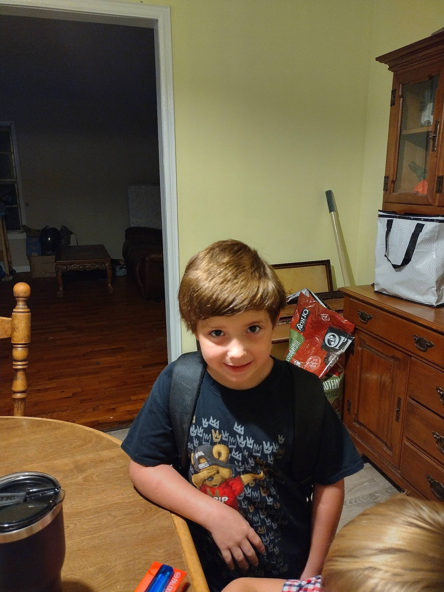 Braxton joined the competition — help win amazing prizes! cabinetry, chair, drawer, event, flooring, fun, furniture, hardwood, home, living_room, person, picture_frame, room, sitting, smile, standing, t_shirt, table, tree, varnish