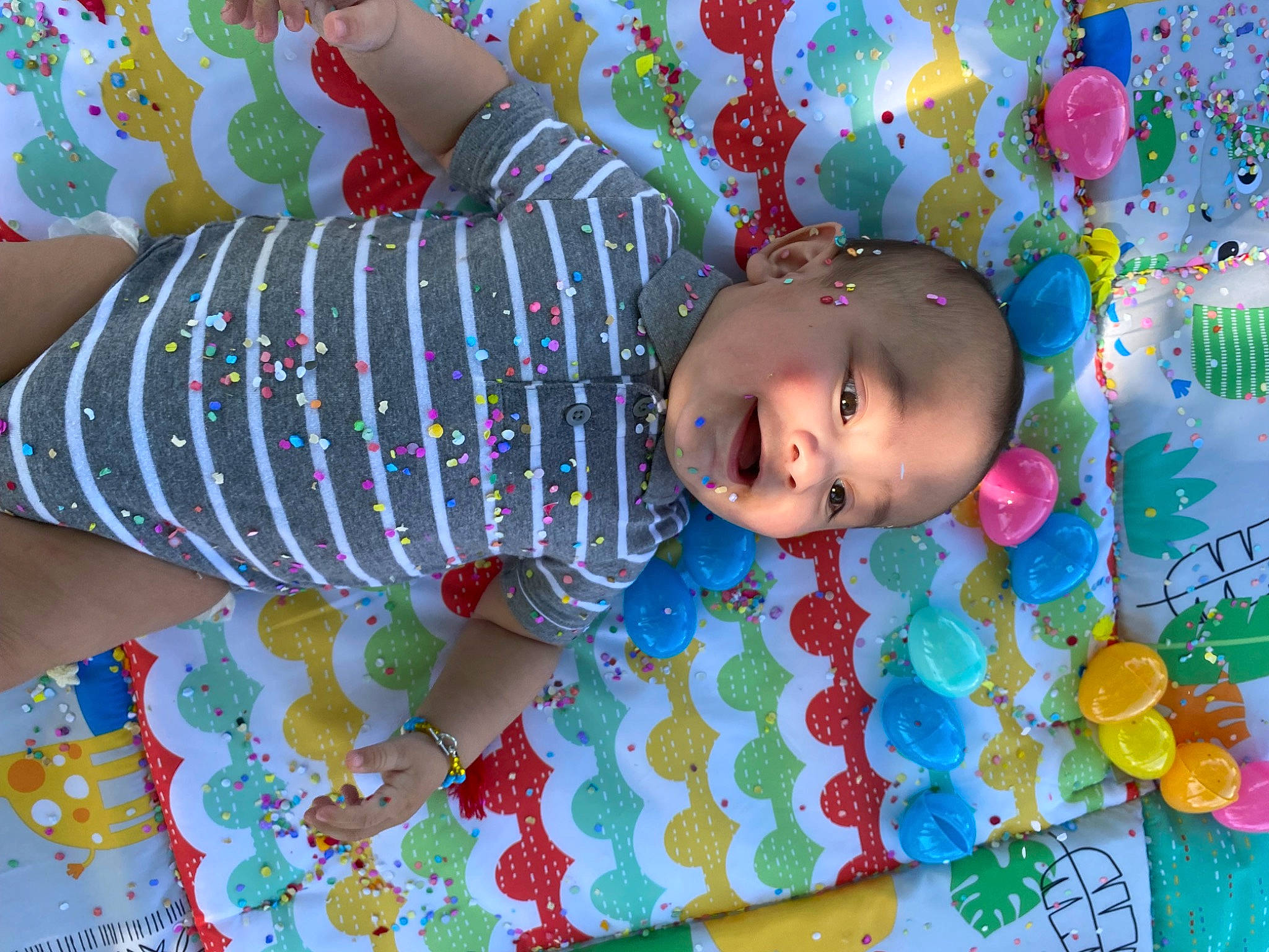 King is registered to the contest to win money with this photo: baby, baby_products, baby_toddler_clothing, baby_toys, child, circle, fun, happy, leisure, linens, magenta, party_supply, pattern, person, play, room, sleeve, smile, textile, toddler