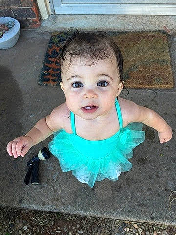 Andi is registered to the contest to win money with this photo: baby, child, costume, face, fun, head, person, play, skin, smile, toddler