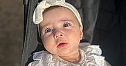 Bella participe au concours pour gagner de l'argent avec cette photo : baby, infant, stroller, white_clothing, headband, bow, sunlight, portrait, closeup, child, cute, outdoor, texture, fabric, face, expression, seatbelt, black_stroller, soft_light, person