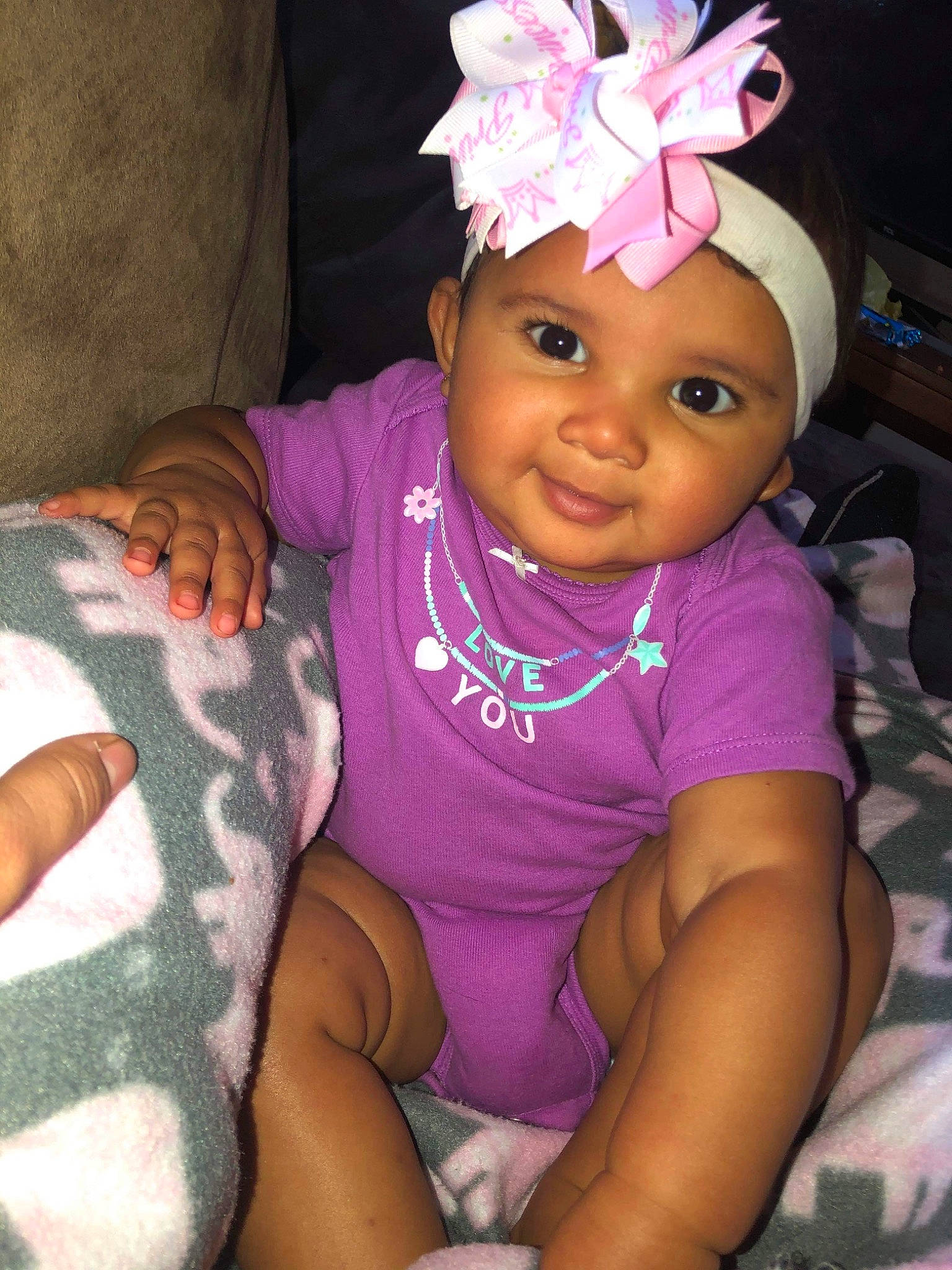 Kavedika is registered to the contest to win money with this photo: baby, baby_toddler_clothing, cheek, child, eye, hair_accessory, head, headband, headgear, headwear, joy, neck, person, pink, skin, smile, toddler