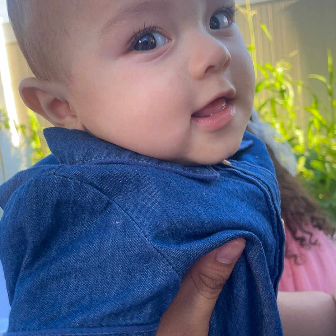 Noah joined the competition — help win amazing prizes! baby, background, blue, child, clothing, curious, daylight, denim, face, fence, hand, happy, holding, nature, outdoor, person, portrait, skin, smile, young