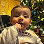 Jacob joined the competition — help win amazing prizes! baby, child, messy_face, food, christmas_tree, holiday, festive, indoors, cute, toddler, clothing, hand, face, portrait, decorations, lights, smiling, family, warm_lighting, person