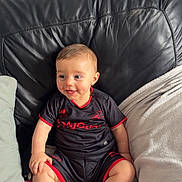 Jacob joined the competition — help win amazing prizes! baby, infant, smiling, sitting, couch, blanket, leather, clothing, happy, child, indoor, portrait, person, cute, young, cozy, comfortable, casual, apparel, home