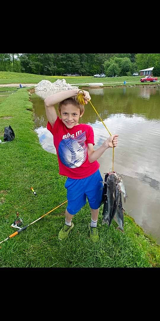 Jaydan joined the competition — help win amazing prizes! angling, boat, fish, fisherman, fishing, fishing_rod, grass, hat, joy, lake, leisure, outdoor_recreation, person, plant, recreation, recreational_fishing, shorts, smile, t_shirt, toddler