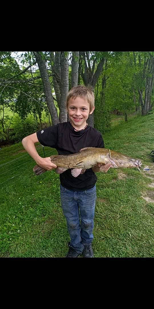 Jaydan is registered to the contest to win money with this photo: burmese_python, crocodile, elbow, fish, grass, joy, people_in_nature, person, plant, python, recreation, reptile, scaled_reptile, serpent, smile, snake, t_shirt, tail, terrestrial_animal, tree