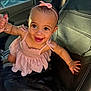 Laylani joined the competition — help win amazing prizes! baby, child, smiling, pink_dress, headband, car_interior, leather_seat, hand_holding, happy, cute, infant, portrait, young_child, sunlight, seat, black_leather, person, indoor, closeup, expressive_face