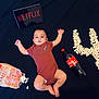 Hratch Shahinyan a rejoint le concours — aidez-le/la à gagner de superbes lots ! baby, infant, popcorn, tablet, netflix, coca_cola, number_four, black_background, lying_down, red_clothing, bottle, snack, spilled_popcorn, child, indoor, relaxing, casual, food, drink, celebration