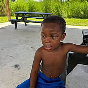 King Davis joined the competition — help win amazing prizes! bench, boy, casual, child, concrete, daylight, expression, grass, greenery, nature, outdoor, park, person, portrait, relaxing, shelter, shorts, summer, sunny, young
