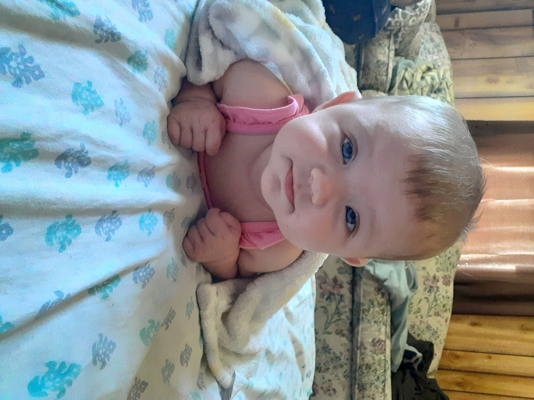 Laura is registered to the contest to win money with this photo: baby, baby_toddler_clothing, cheek, child, comfort, dress, eye, face, grass, happy, iris, linens, nose, pattern, person, product, skin, sleeve, smile, toddler