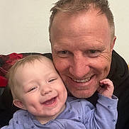Hazel joined the competition — help win amazing prizes! adult, affection, baby, bonding, casual_clothing, child, closeup, dimples, face, happy, hug, indoor, joy, light_skinned, male, parent, person, portrait, smile, toddler