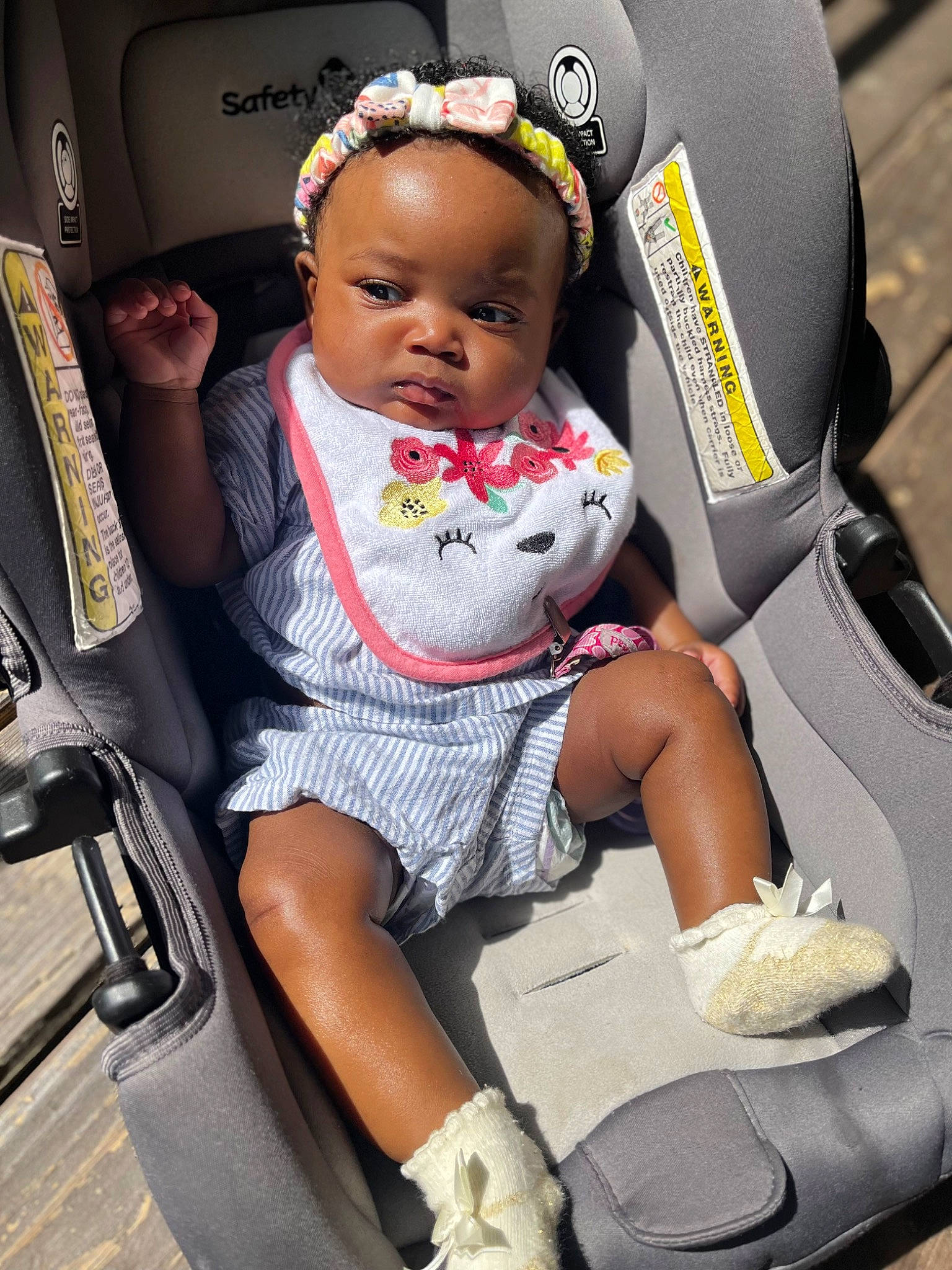 Ameiah is registered to the contest to win money with this photo: auto_part, baby, baby_carriage, baby_in_car_seat, baby_products, baby_safety, baby_toddler_clothing, car_seat, car_seat_cover, child, comfort, dress, fun, human_leg, lap, person, photograph, sitting, sneakers, thigh