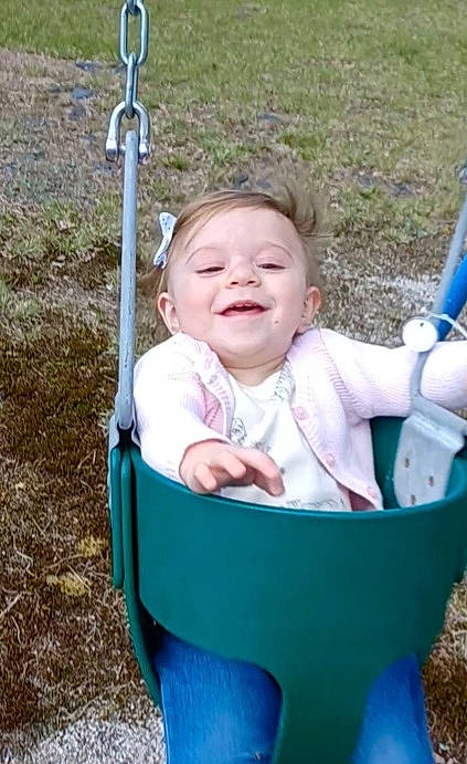 Natalie is registered to the contest to win money with this photo: baby, baby_products, baby_toddler_clothing, blue, cheek, child, eye, face, fun, grass, happy, joy, leisure, people_in_nature, person, play, recreation, sitting, skin, smile