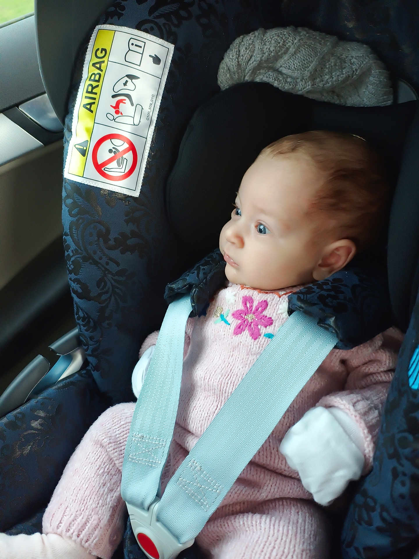 Ruxandra is registered to the contest to win money with this photo: baby, blue_eyes, car_interior, car_seat, child, child_safety, cute, infant, knitted, looking, mittens, pink_clothing, portrait, safety, seat, seatbelt, side_view, soft_lighting, window, young_child
