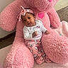 Yeilani is registered to the contest to win money with this photo: baby, child, pink, teddy_bear, plush_toy, hello_kitty, pajamas, headband, carpet, soft_texture, indoor, cute, cozy, smile, person, toy, floor, comfort, infant, relaxing