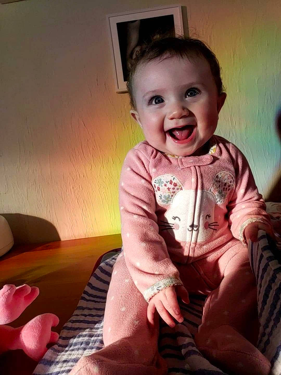 Lilith is registered to the contest to win money with this photo: baby, baby_toddler_clothing, cheek, chin, comfort, cool, flash_photography, happy, human_body, iris, joy, lip, mouth, person, pink, shoulder, skin, sleeve, smile, standing