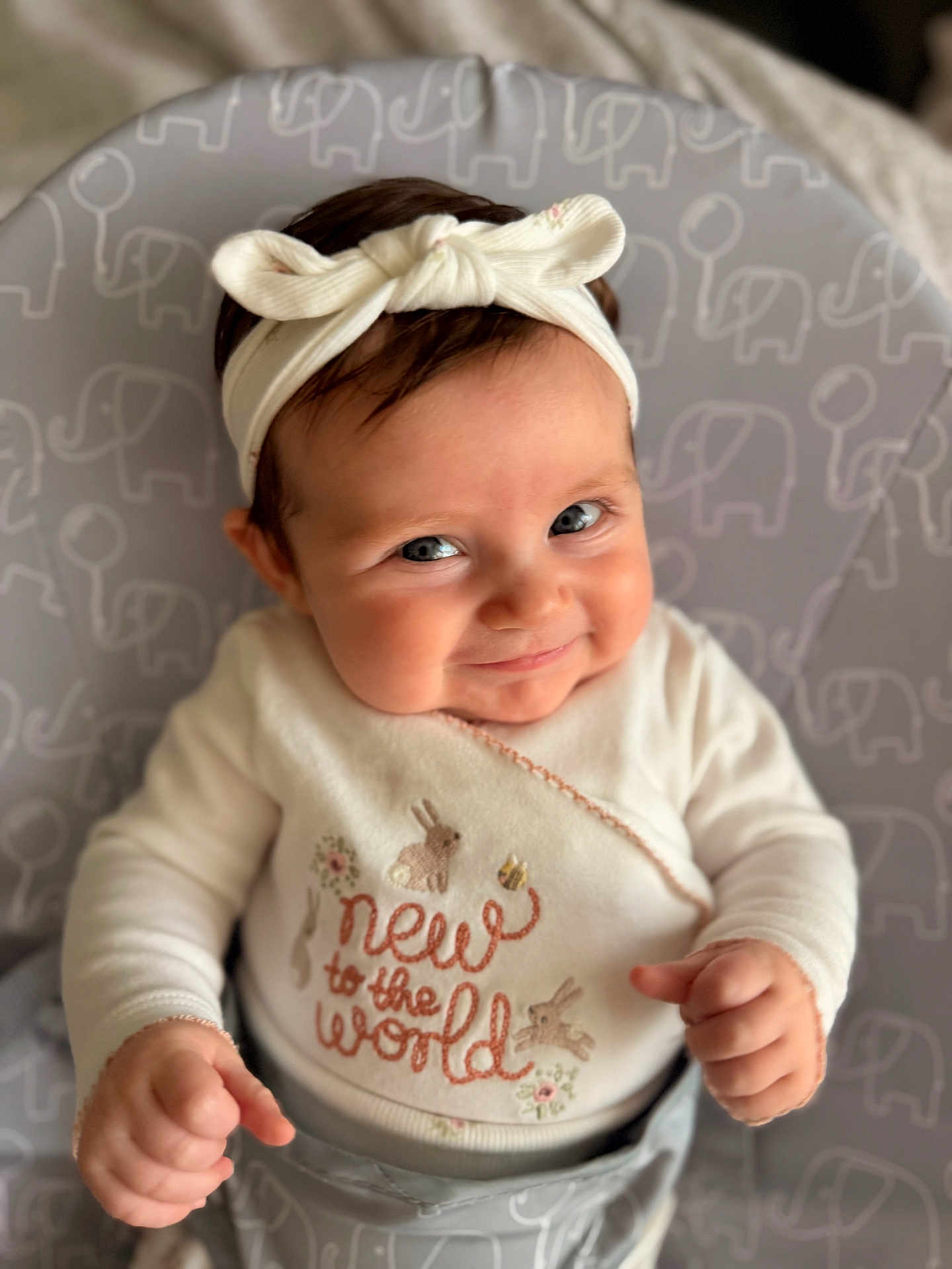 Elizabeth joined the competition — help win amazing prizes! baby, child, headband, smile, cute, indoor, sweater, pattern, elephant, bunny, face, portrait, infant, cushion, clothing, happy, person, sitting, closeup, cozy
