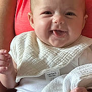 Oaklyn is registered to the contest to win money with this photo: arm, baby, bib, blanket, closeup, cute, fabric, face, hand, happy, holding, indoor, infant, newborn, parent, person, skin, smiling, tongue_out, white_clothing