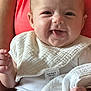 arm, baby, bib, blanket, closeup, cute, fabric, face, hand, happy, holding, indoor, infant, newborn, parent, person, skin, smiling, tongue_out, white_clothing
