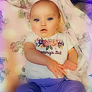 Samara joined the competition — help win amazing prizes! baby, infant, child, blanket, floral, clothing, shirt, pants, lying_down, hands, face, blue_eyes, cute, indoors, pastel_colors, soft_lighting, portrait, young_child, expression, comfort