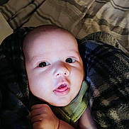 Hunter joined the competition — help win amazing prizes! baby, infant, face, blanket, closeup, expression, cute, child, skin, hand, eyes, mouth, cozy, soft, young, portrait, indoors, person, warm, sleepwear