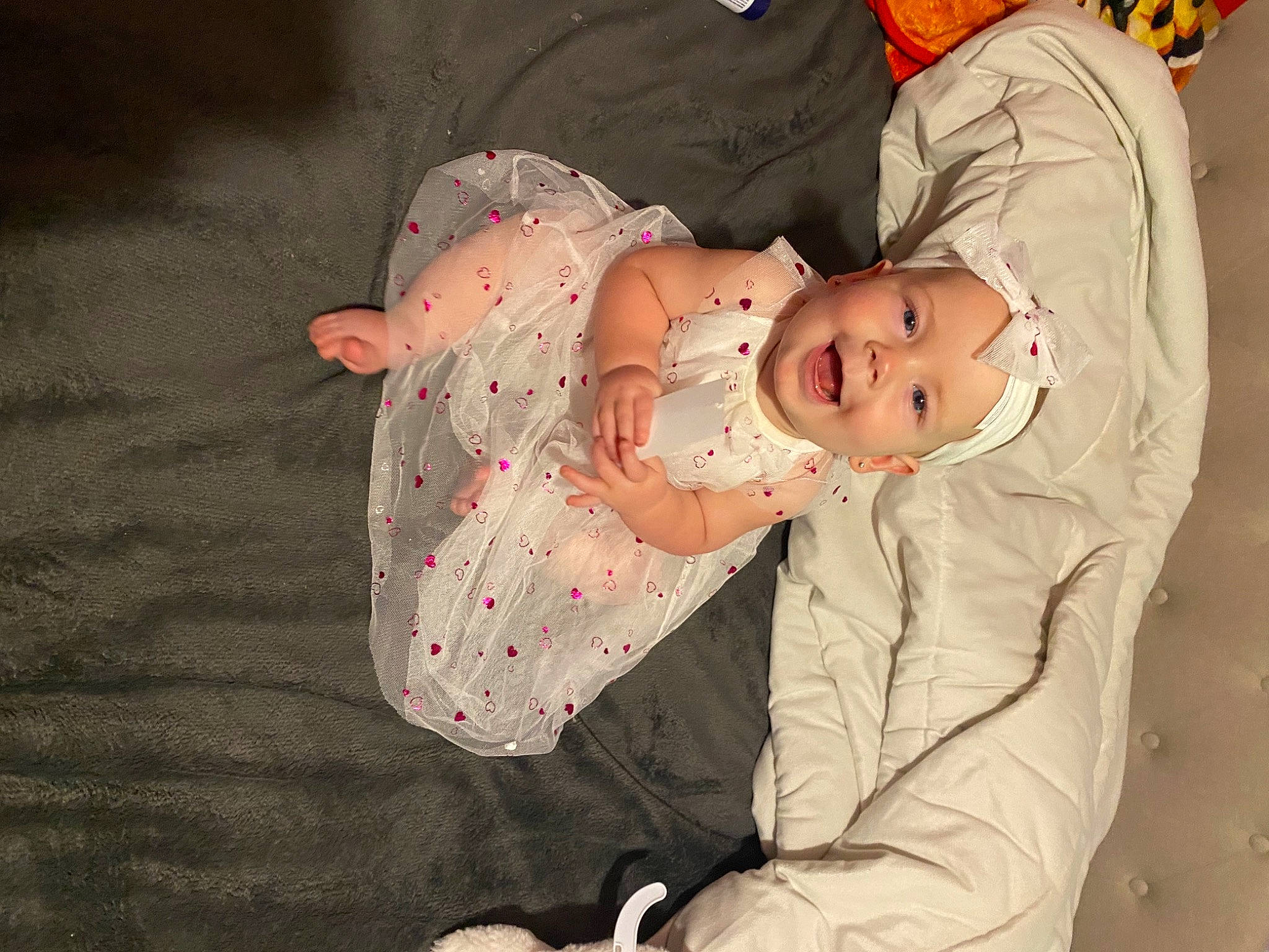 Amantha Annalynn is registered to the contest to win money with this photo: baby, baby_products, baby_safety, baby_toddler_clothing, child, comfort, event, finger, fun, headwear, human_body, joy, linens, pattern, person, room, sitting, skin, sleeve, textile