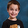 child, boy, smiling, portrait, tshirt, halloween, pumpkin, jack_skellington, black_clothing, studio_background, short_hair, happy, person, face, casual, youth, cute, expression, indoors, photograph