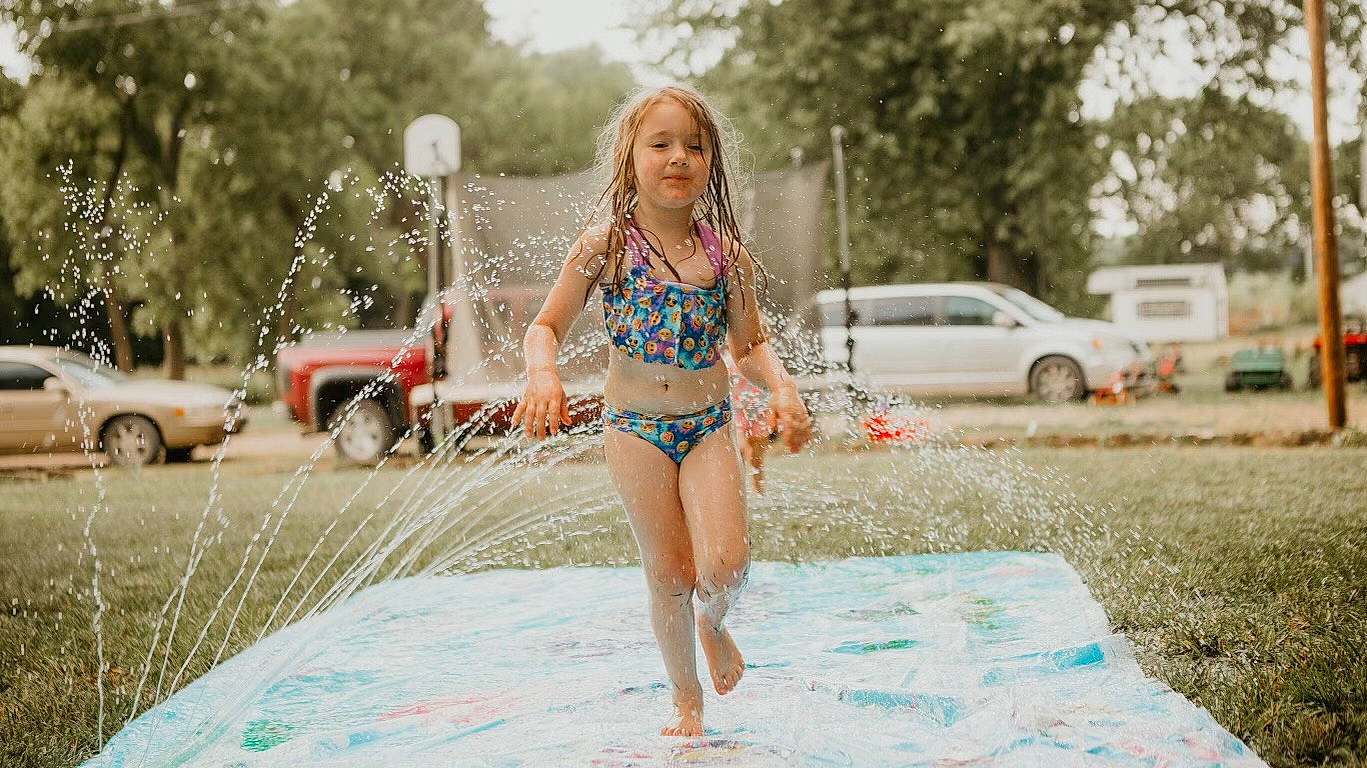 Paislee is registered to the contest to win money with this photo: brassiere, car, fun, grass, hair, happy, leisure, long_hair, navel, person, street_fashion, swimsuit_top, swimwear, thigh, tire, undergarment, underpants, vehicle, waist, wheel