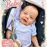 Charika is registered to the contest to win money with this photo: baby, infant, blue_eyes, onesie, knitted_toy, carrier, heart_shape, smiling, cute, pastel_colors, vignette, child, soft_light, portrait, happy, young_child, indoors, closeup, baby_clothing, playful